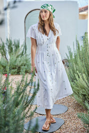 Model Tegand wearing size 10 of the Flower Field Cotton Embroidered Dress – White in colour White, from the front