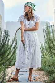 Model Tegand wearing size 10 of the Flower Field Cotton Embroidered Dress – White in colour White, from the front