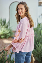 Model Tegand wearing size 10 of the Loving You Is Easy Embroidered Cotton Blouse  - Pinktangerine in colour Pinktangerine, from an angle