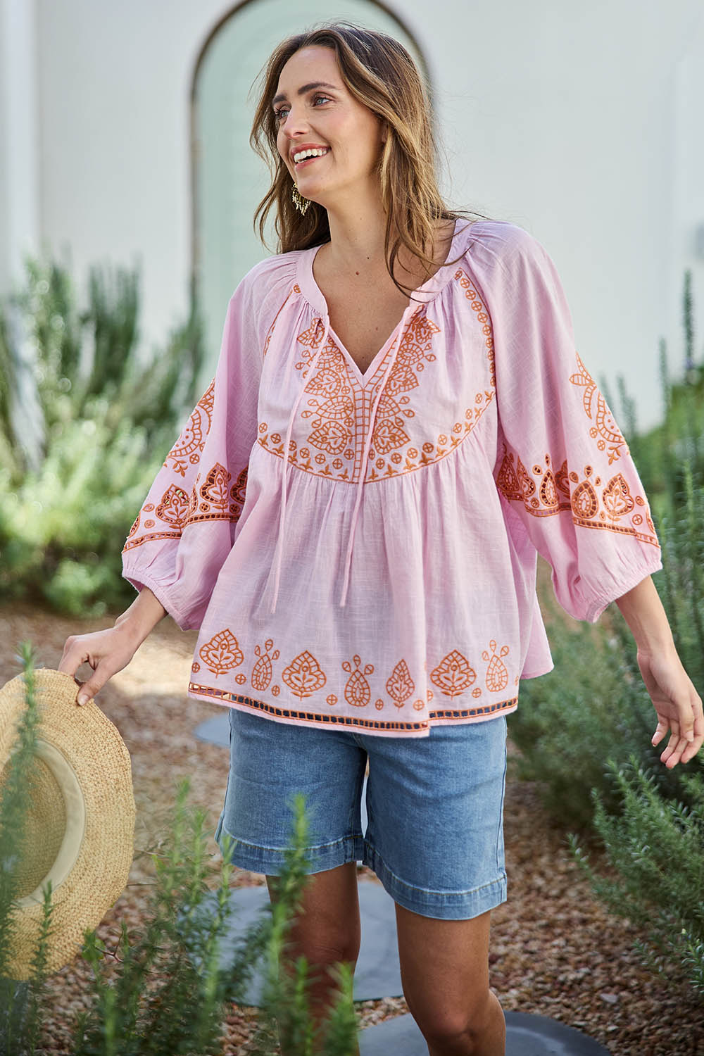 Model Tegand wearing size 10 of the Loving You Is Easy Embroidered Cotton Blouse  - Pinktangerine in colour Pinktangerine, in a cropped view