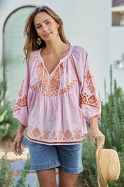 Model Tegand wearing size 10 of the Loving You Is Easy Embroidered Cotton Blouse  - Pinktangerine in colour Pinktangerine, in a cropped view