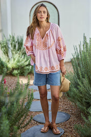 Model Tegand wearing size 10 of the Loving You Is Easy Embroidered Cotton Blouse  - Pinktangerine in colour Pinktangerine, from the front