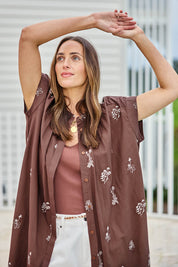 Model Tegand wearing size 10 of the Wildflower Embroidered Cotton Tunic Dress – Chocolate in colour Chocolate, in a cropped view
