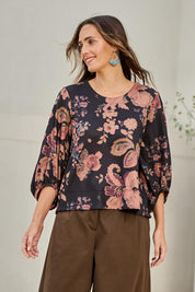 Model Tegand wearing size 10 of the Flowers For Me Balloon Sleeve Top – Blackfleur in colour Blackfleur, in a cropped view