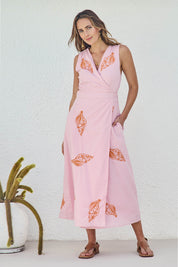 Model Tegand wearing size 10 of the Sweet Pea Embroidered Cotton Wrap Dress - Pinktangerine in colour Pinktangerine, from the front