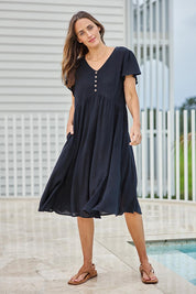 Model Tegand wearing size 10 of the Cute As A Button Cotton Midi Dress – Black in colour Black, from the front