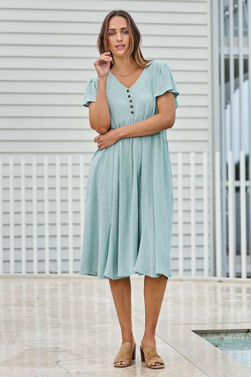 Model Tegand wearing size 10 of the Cute As A Button Cotton Midi Dress – Sage in colour Sage, from the front