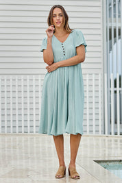 Model Tegand wearing size 10 of the Cute As A Button Cotton Midi Dress – Sage in colour Sage, from the front