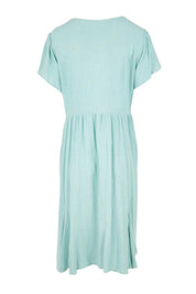 Product shot of the Cute As A Button Cotton Midi Dress – Sage in colour Sage, from the back
