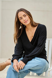 Model Tegand wearing size 10 of the Cross My Heart Sweater – Black in colour Black, in a cropped view