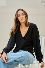 Model Tegand wearing size 10 of the Cross My Heart Sweater – Black in colour Black, in a cropped view