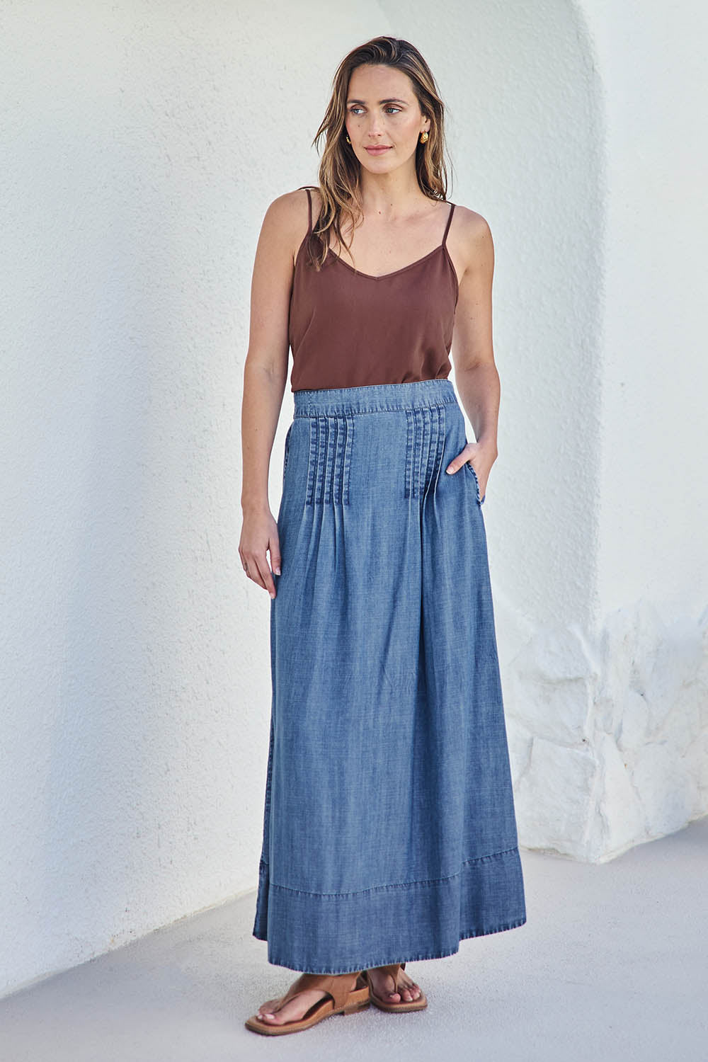 Model Tegand wearing size 10 of the Perfect Day Pleat Detail Lyocell Maxi Skirt – Denim in colour Denim, from the front