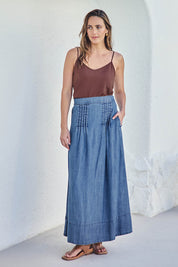 Model Tegand wearing size 10 of the Perfect Day Pleat Detail Lyocell Maxi Skirt – Denim in colour Denim, from the front