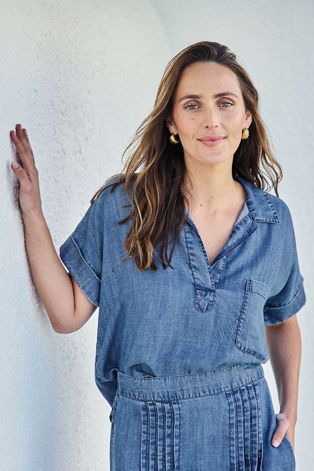 Model Tegand wearing size 10 of the Perfect Day Lyocell Popover Shirt – Denim in colour Denim, in a cropped view