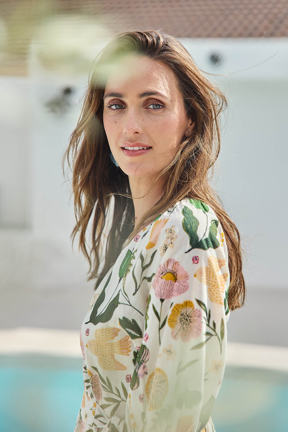 Model Tegand wearing size 10 of the Frill of Birds Cotton Wrap Dress - Birdfleur in colour Birdfleur, from an angle
