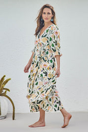 Model Tegand wearing size 10 of the Frill of Birds Cotton Wrap Dress - Birdfleur in colour Birdfleur, from the front