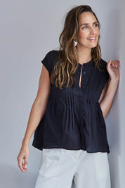 Model Tegand wearing size 10 of the Easy Love Pintuck Cotton Blouse – Black in colour Black, from an angle