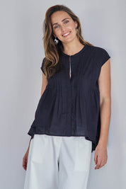 Model Tegand wearing size 10 of the Easy Love Pintuck Cotton Blouse – Black in colour Black, in a cropped view