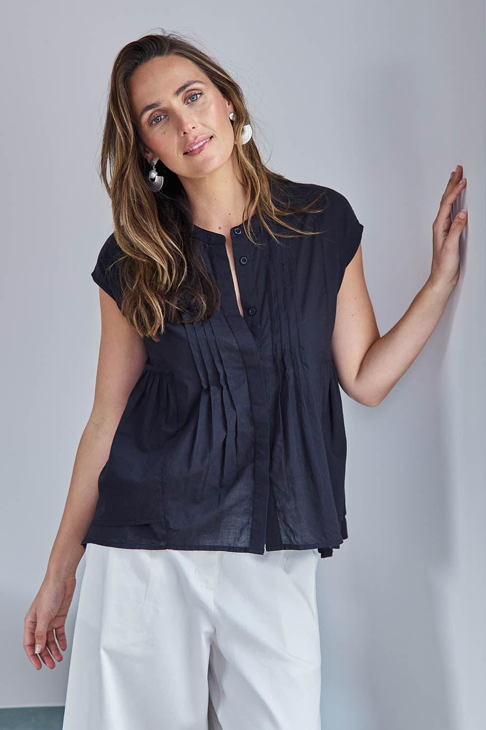 Model Tegand wearing size 10 of the Easy Love Pintuck Cotton Blouse – Black in colour Black, in a cropped view