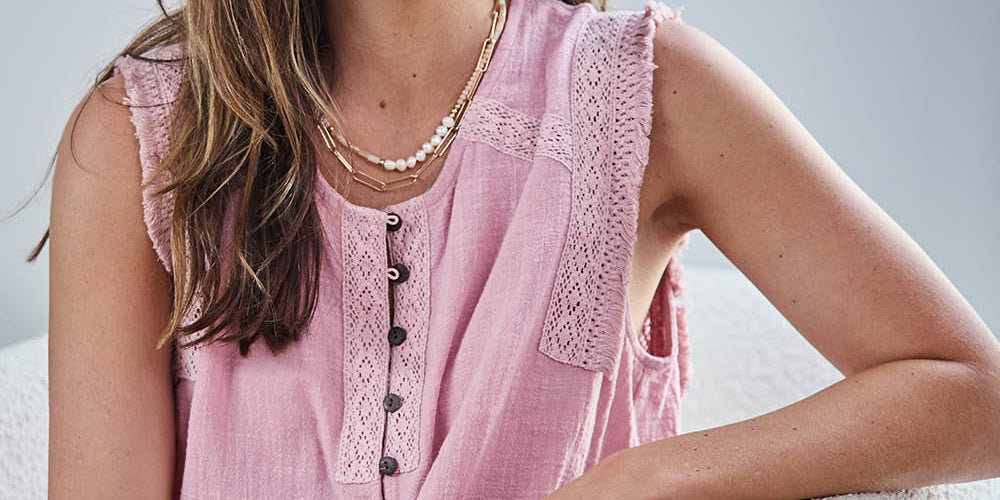 Model Tegand wearing size 10 of the Cute As A Button Fringed Tank – Rose in colour Rose, in a cropped view