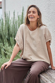 Model Tegand wearing size 10 of the Sun Gazer Balloon Sleeve Top – Sand in colour Sand, from an angle