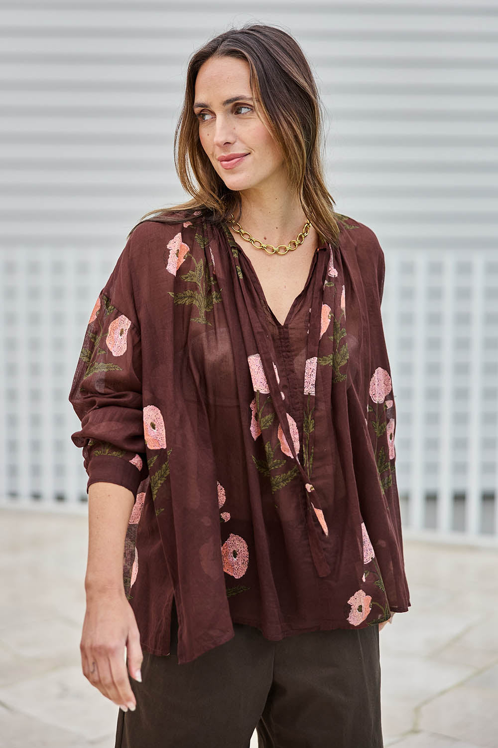 Model Tegand wearing size 10 of the I Can Buy Myself Flowers Blouse – Wine in colour Wine, from an angle