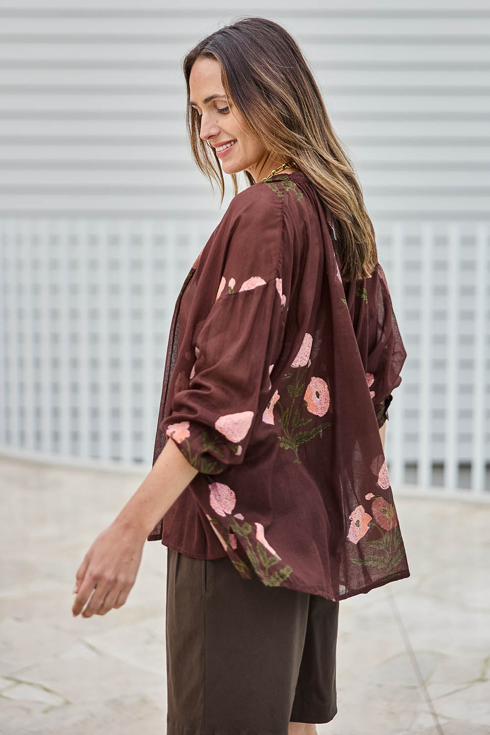 Model Tegand wearing size 10 of the I Can Buy Myself Flowers Blouse – Wine in colour Wine, from an angle