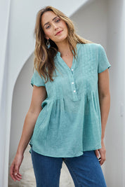 Model Tegand wearing size 10 of the Pleated Delight Cotton Blouse – Mint in colour Mint, in a cropped view