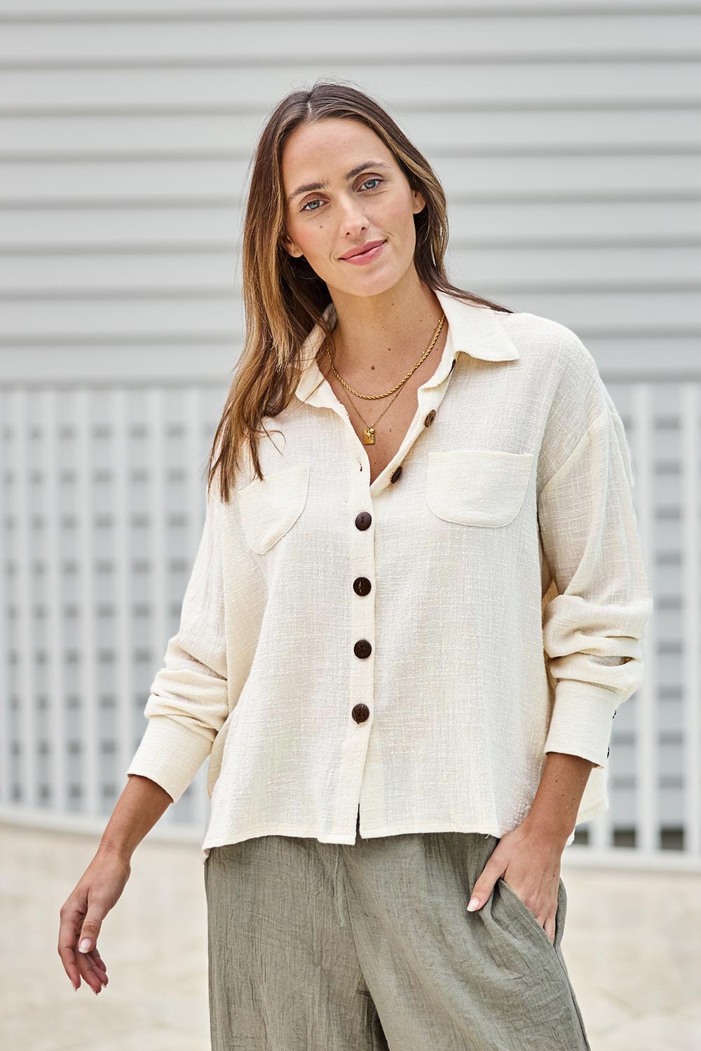Model Tegand wearing size 10 of the Cute As A Button Cotton Shirt - Birch in colour Birch, in a cropped view