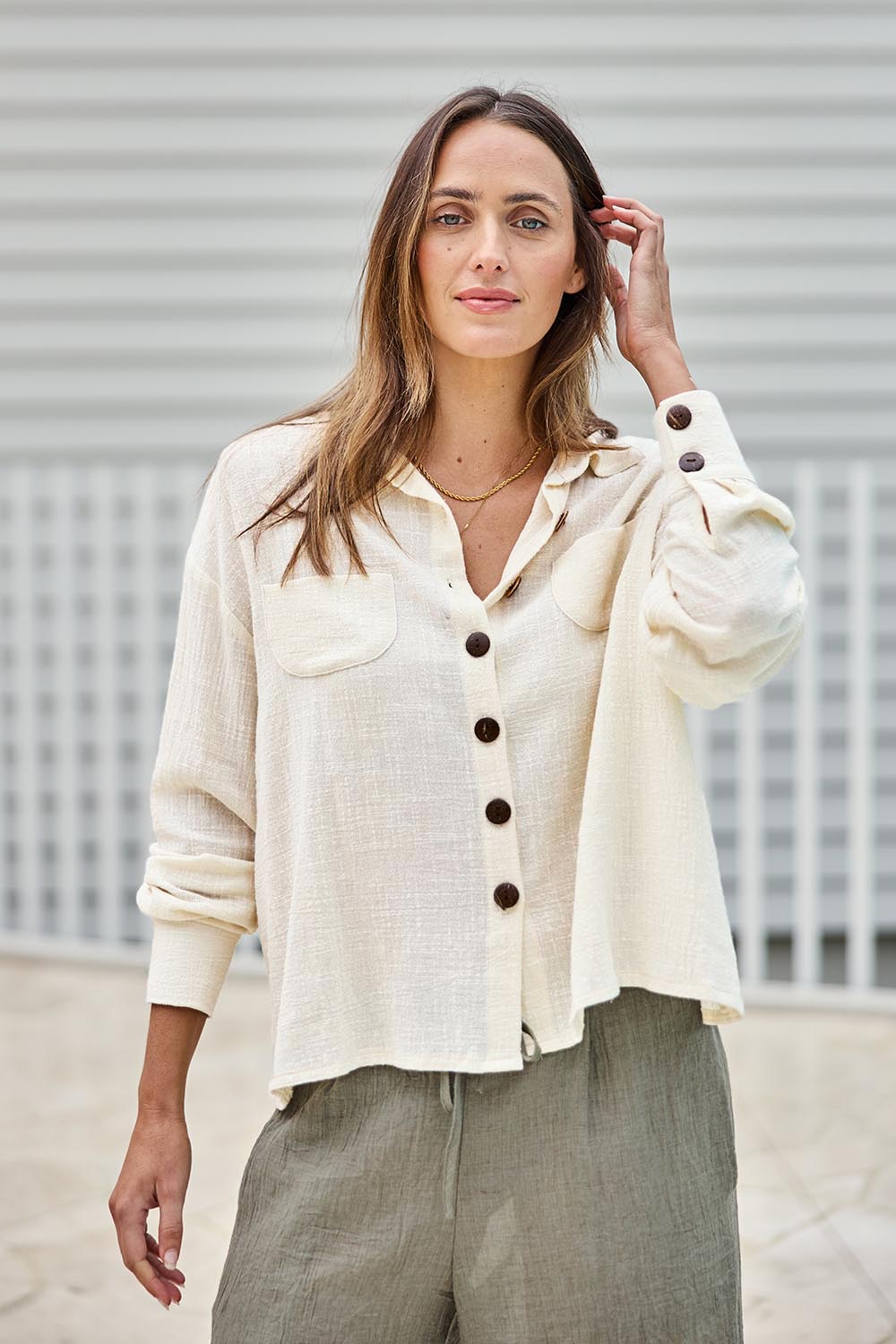 Model Tegand wearing size 10 of the Cute As A Button Cotton Shirt - Birch in colour Birch, in a cropped view