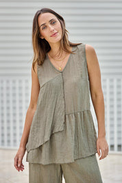 Model Tegand wearing size 10 of the Floating Through The Day Singlet - Olive in colour Olive, in a cropped view