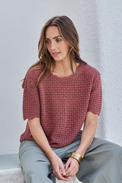 Model Tegand wearing size 10 of the Sunset Stroll Knit Top - Rosewood in colour Rosewood, in a cropped view