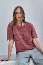 Model Tegand wearing size 10 of the Sunset Stroll Knit Top - Rosewood in colour Rosewood, in a cropped view