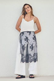 Model Tegand wearing size 10 of the Last Dance Lace Overlay Skirt - Black in colour Black, from the front