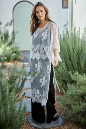 Model Tegand wearing size 10 of the Last Dance Lace Overlay Skirt - White in colour White, from the front