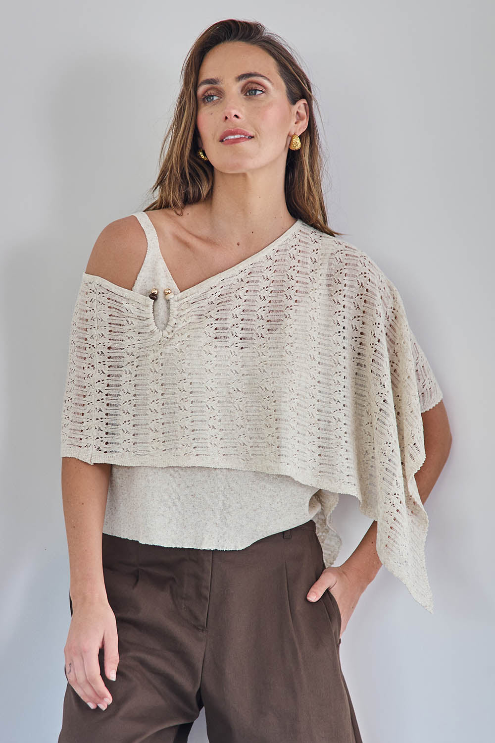 Model Tegand wearing size 10 of the Golden Hour Knit Top And Poncho Set - Natural in colour Natural, in a cropped view