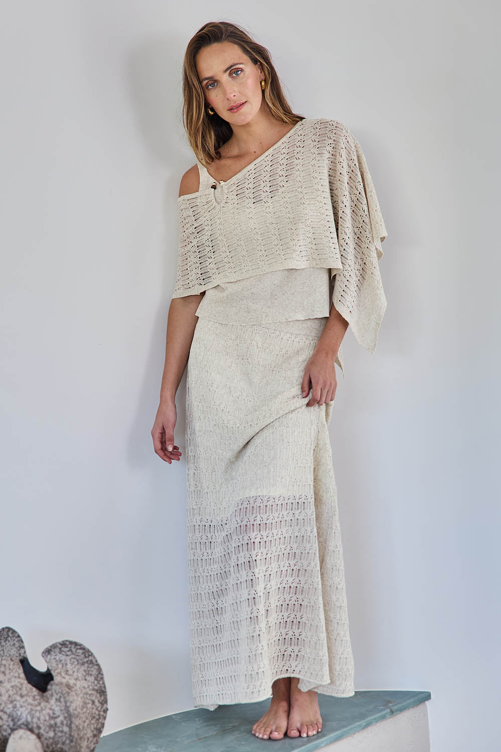 Model Tegand wearing size 10 of the Golden Hour Knit Top And Poncho Set - Natural in colour Natural, from the front