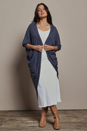 Model Tahnee wearing size 10 of the Falling For You Cardi in colour Denim (Blue), from the front, showing the whole outfit