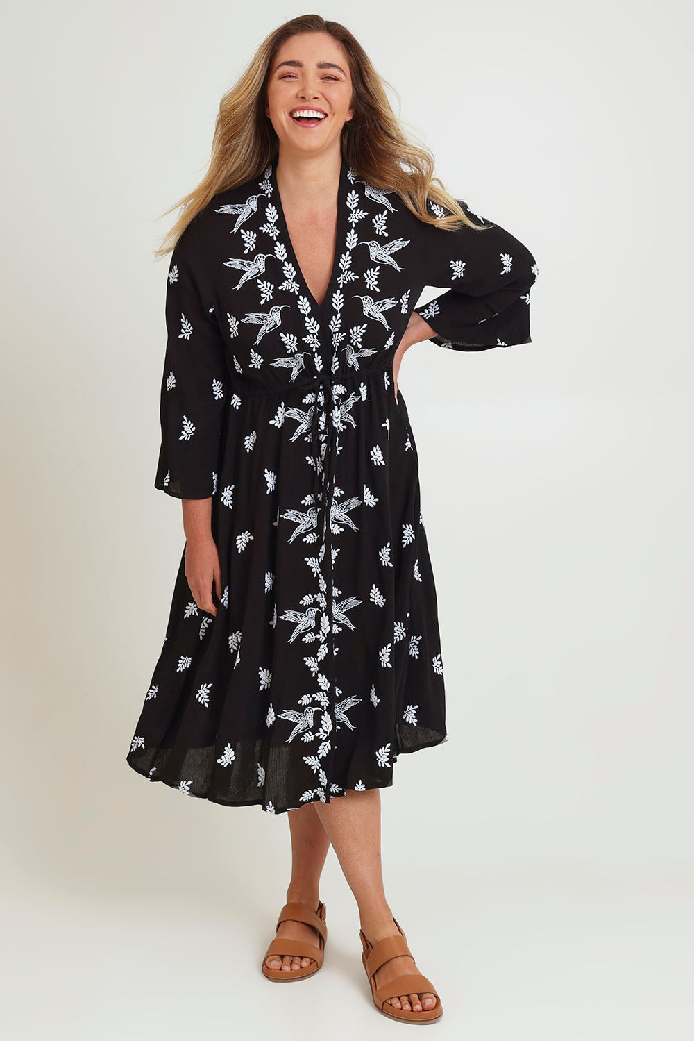 Model Chanel wearing size 16 of the Dancing With Birds Midi Dress in colour Black (Black), from the front, showing the whole outfit