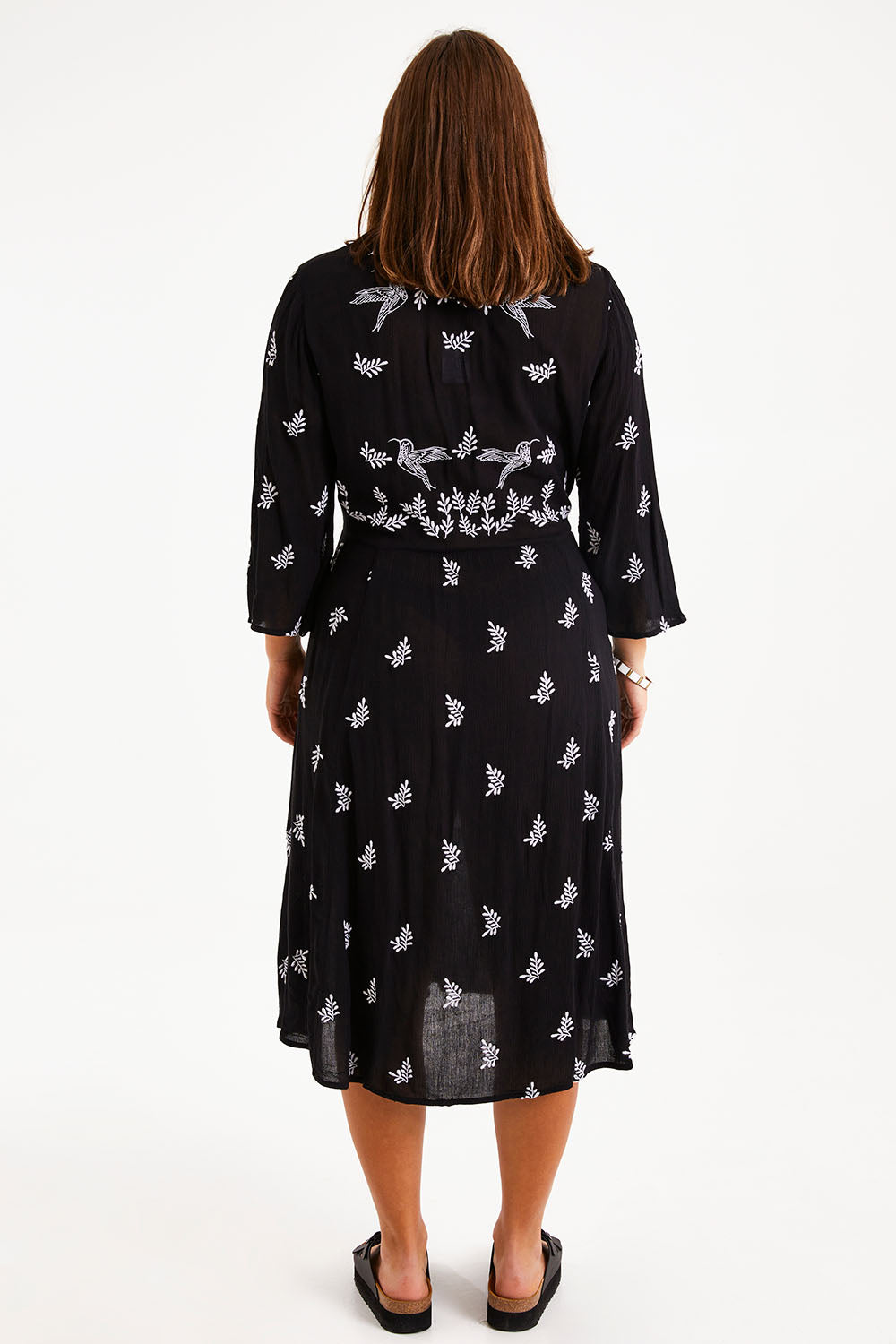 Model Monique wearing size 14 of the Dancing With Birds Midi Dress in colour Black (Black), from the back