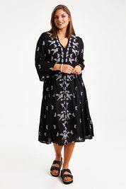 Model Monique wearing size 14 of the Dancing With Birds Midi Dress in colour Black (Black), from the front, showing the whole outfit