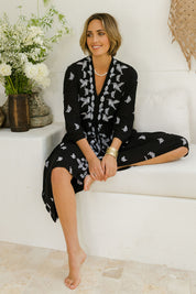 Model Tegan wearing size 10 of the Dancing With Birds Midi Dress in colour Black (Black), from the front, showing the whole outfit
