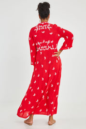 Model Noli wearing size 14 of the Dancing With Birds Dress in colour Scarlet (Red), from the back
