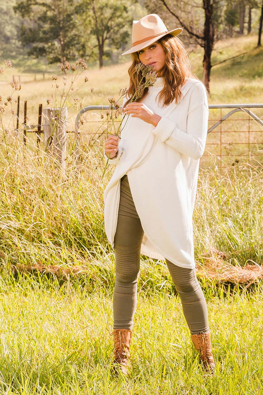 Model Ilona wearing size S of the Crossing The Plains Cotton Sweater in colour Snow (White), from the front, showing the whole outfit