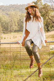 Model Ilona wearing size S of the Crossing The Plains Cotton Sweater in colour Snow (White), from the front, showing the whole outfit