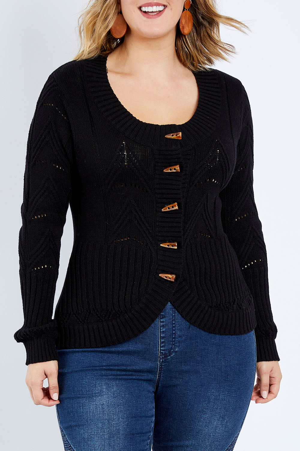 Model Jess wearing size L of the Fireside Button Cardigan in colour Black (Black), from the front, cropped image