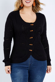 Model Jess wearing size L of the Fireside Button Cardigan in colour Black (Black), from the front, cropped image