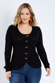 Model Jess wearing size L of the Fireside Button Cardigan in colour Black (Black), from the front, cropped image