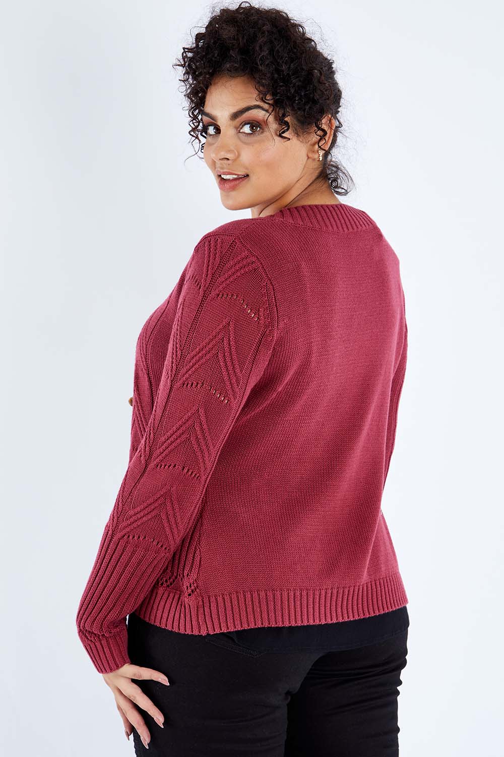 Model Sasha-Lee wearing size XL of the Fireside Button Cardigan in colour Plum (Red), from the back