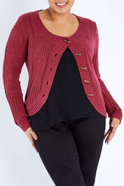 Model Sasha-Lee wearing size XL of the Fireside Button Cardigan in colour Plum (Red), from the front, cropped image